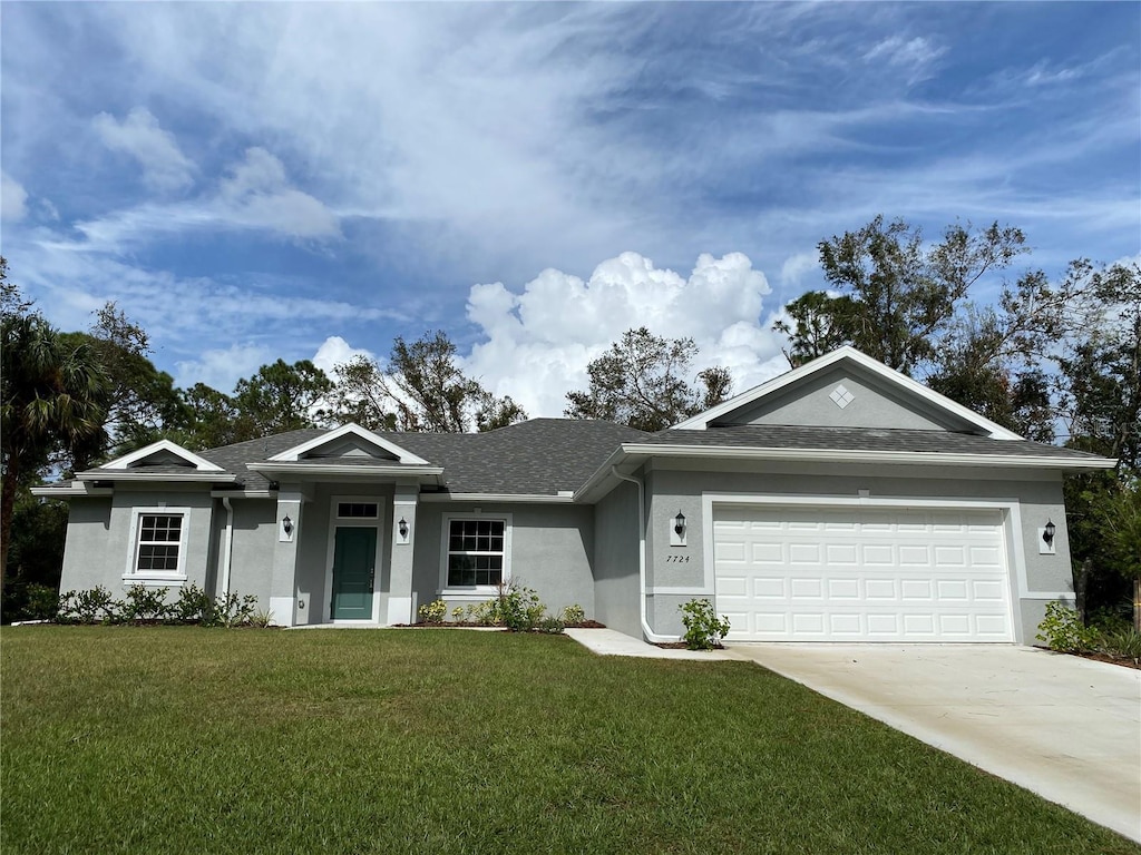 ranch-style house featuring a garage and a front yard