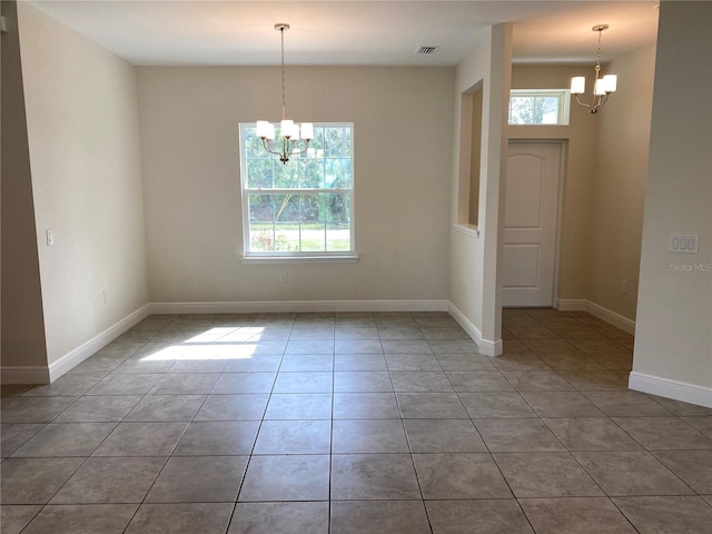 interior space with light tile patterned floors, visible vents, baseboards, and an inviting chandelier