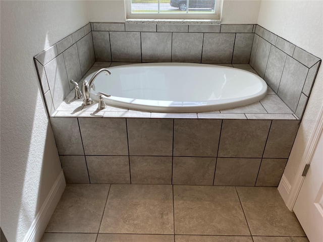 bathroom featuring tile patterned floors and a bath