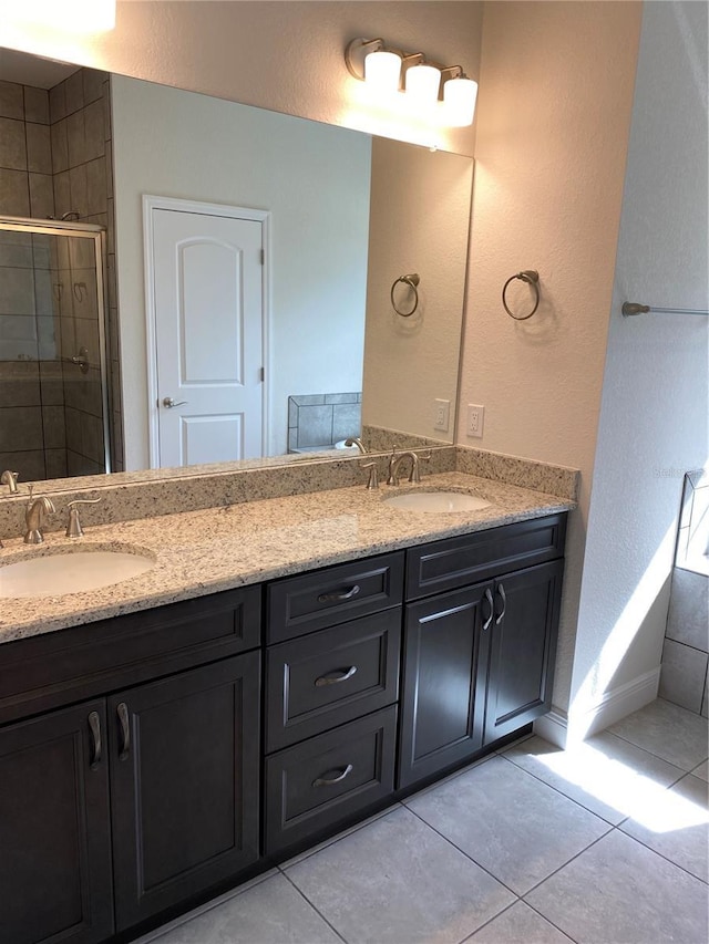 bathroom featuring double vanity, tile patterned flooring, and a sink