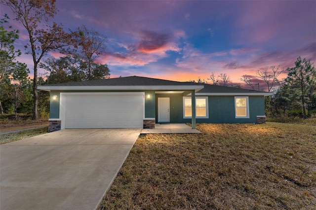 view of front of property featuring a garage and a yard