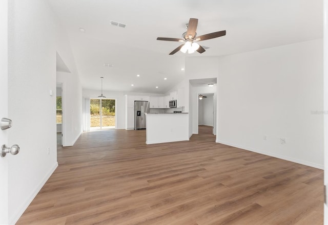 unfurnished living room featuring ceiling fan, light hardwood / wood-style floors, and lofted ceiling