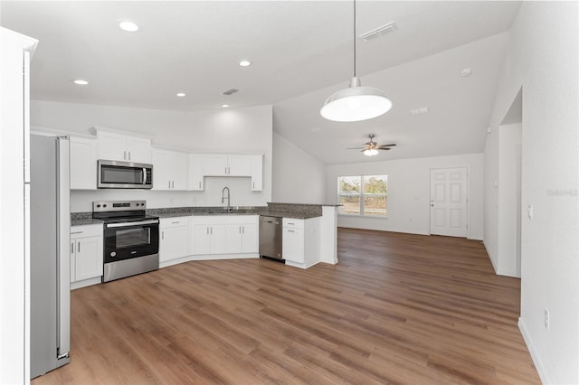 kitchen with stainless steel appliances, sink, decorative light fixtures, white cabinets, and ceiling fan