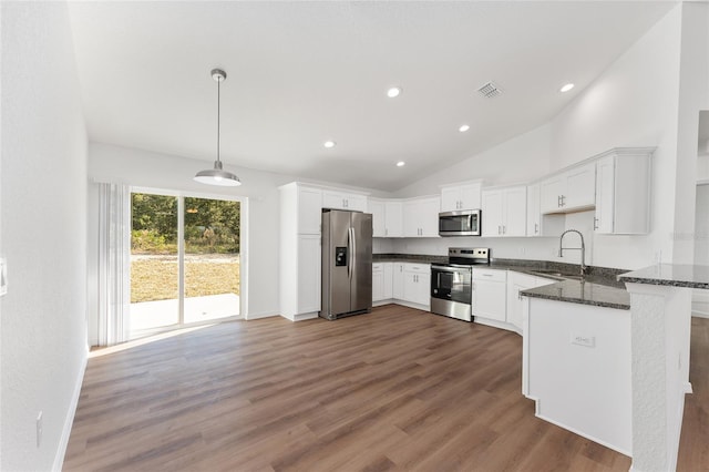 kitchen featuring appliances with stainless steel finishes, white cabinets, decorative light fixtures, and sink