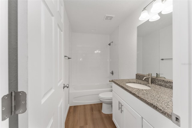 full bathroom with shower / bathing tub combination, toilet, vanity, and hardwood / wood-style flooring