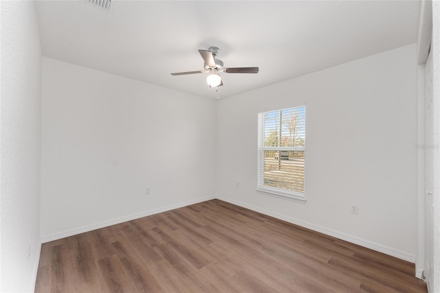 spare room with ceiling fan and wood-type flooring