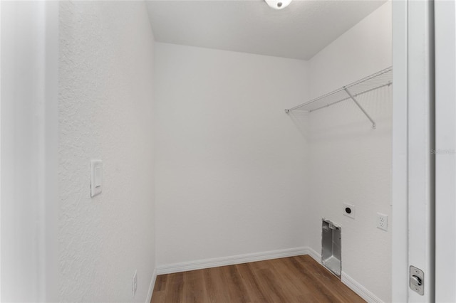 laundry area featuring electric dryer hookup and wood-type flooring