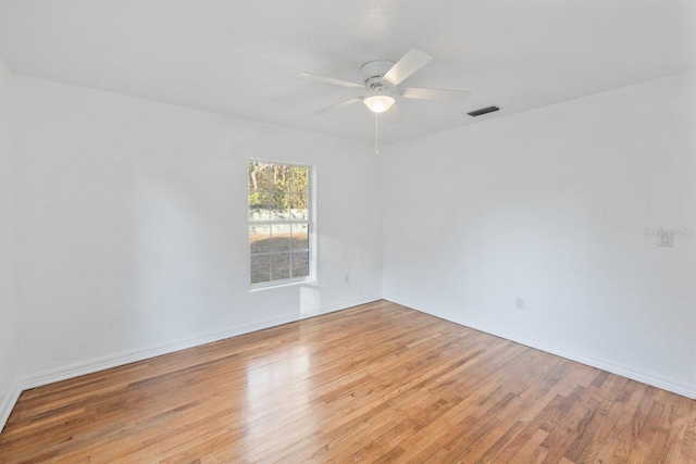 empty room featuring ceiling fan and light hardwood / wood-style flooring