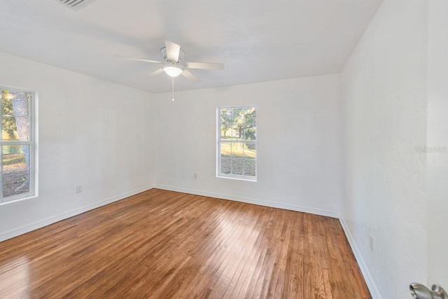 unfurnished room with ceiling fan and hardwood / wood-style flooring