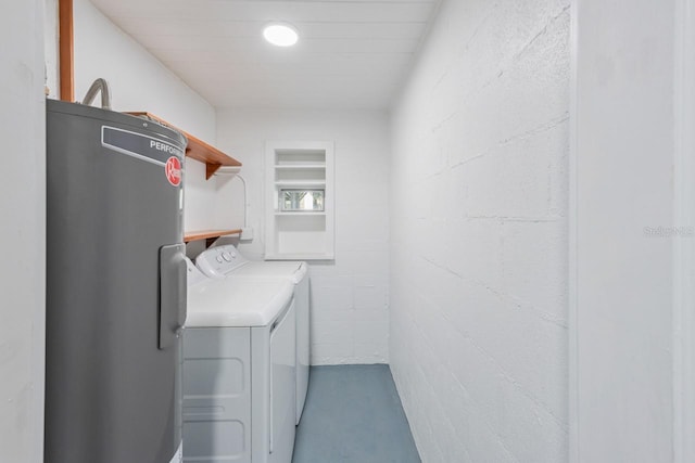 washroom featuring separate washer and dryer and electric water heater