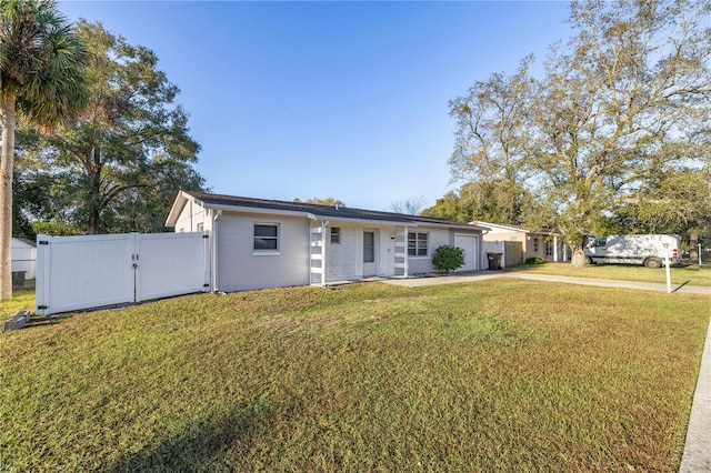 single story home featuring a front lawn and a garage