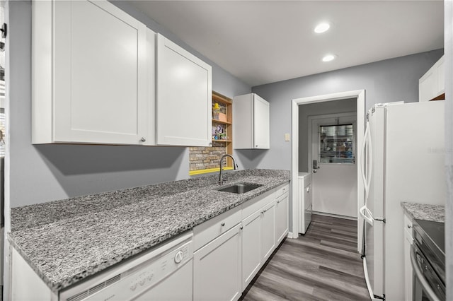 kitchen featuring white appliances, white cabinetry, and light stone counters