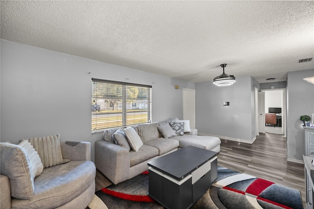 living room featuring a textured ceiling and dark wood-type flooring