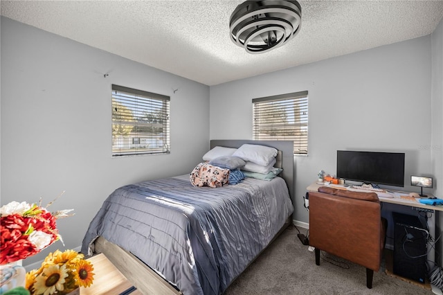 bedroom featuring a textured ceiling and light carpet