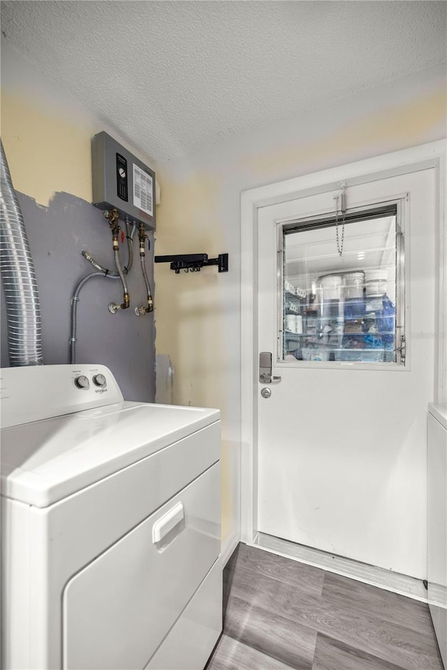 washroom featuring washer / dryer, a textured ceiling, and hardwood / wood-style floors