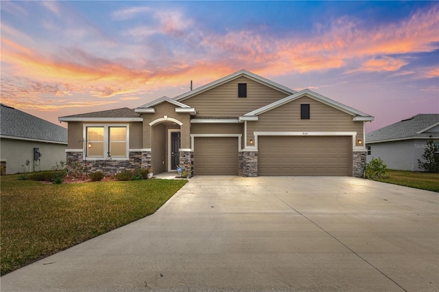 view of front of property featuring a garage and a yard