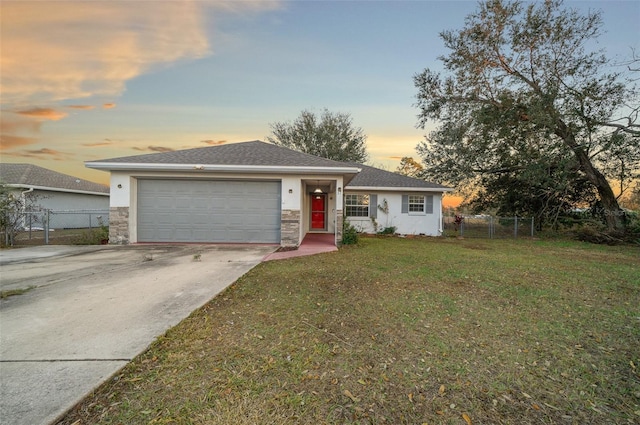 view of front of home featuring a garage and a yard