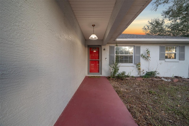 view of exterior entry at dusk