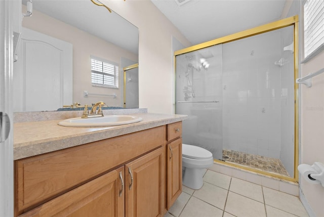 bathroom with toilet, a shower with door, tile patterned floors, and vanity