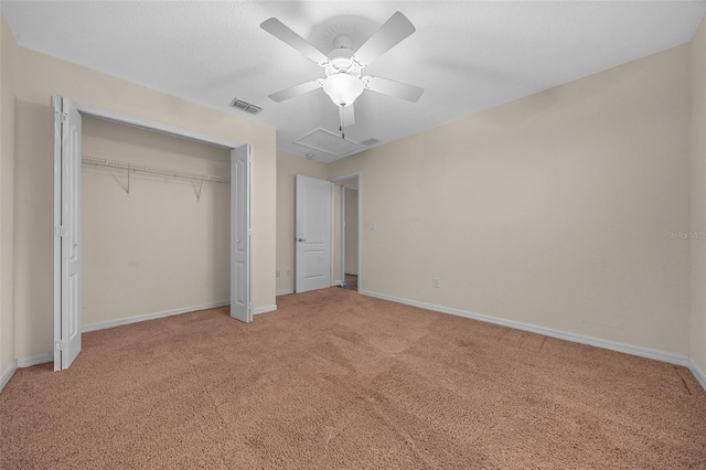 unfurnished bedroom with ceiling fan, a closet, and carpet