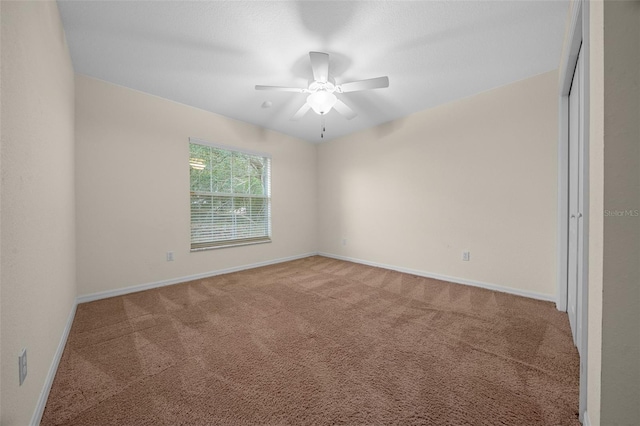 unfurnished room with carpet flooring and ceiling fan