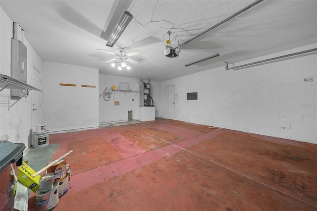 garage with a garage door opener, ceiling fan, and heating unit