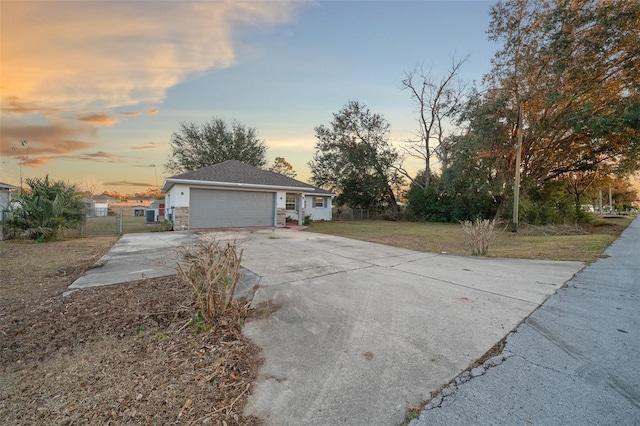 view of front of property with a yard and a garage