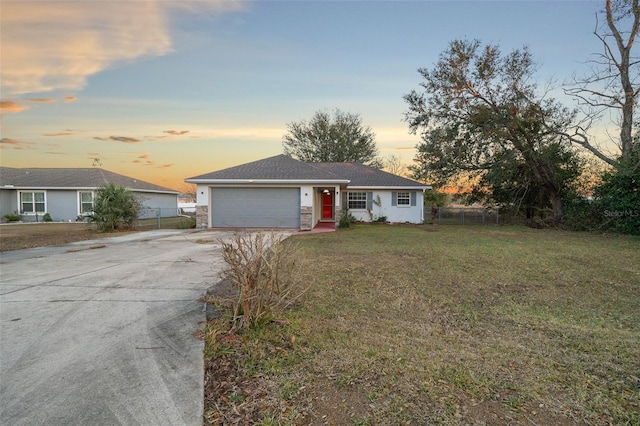 single story home with a yard and a garage