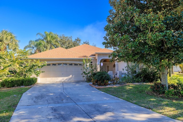 view of front of house with a front lawn and a garage