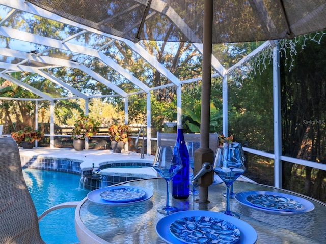 view of pool with pool water feature, a lanai, an in ground hot tub, and a patio area