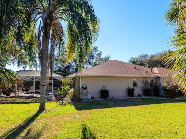 view of home's exterior featuring a lanai and a lawn