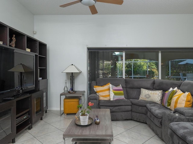 tiled living room with a textured ceiling and ceiling fan