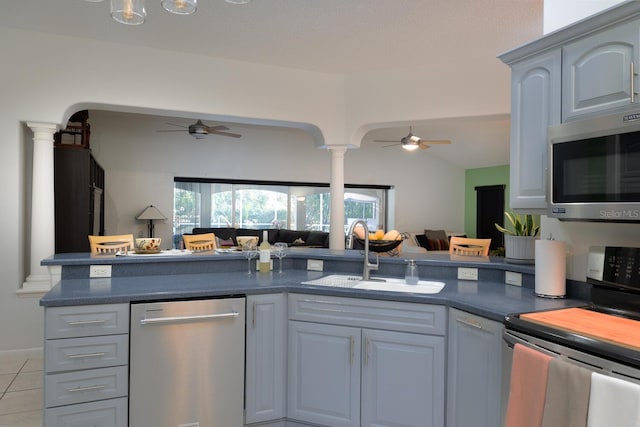 kitchen featuring appliances with stainless steel finishes, ceiling fan, gray cabinets, and sink