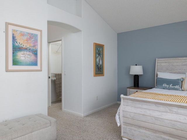 carpeted bedroom featuring a closet, a textured ceiling, and vaulted ceiling