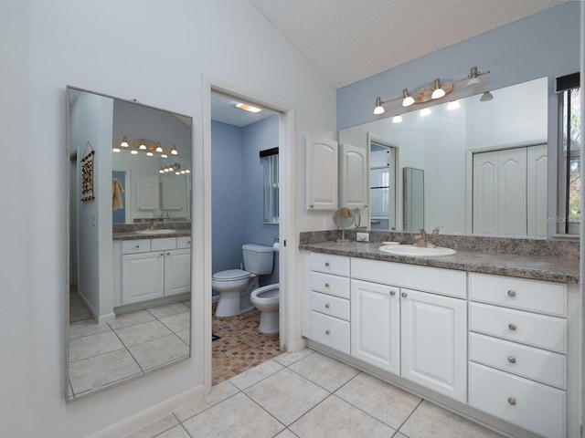 bathroom featuring a bidet, tile patterned floors, vanity, a textured ceiling, and lofted ceiling