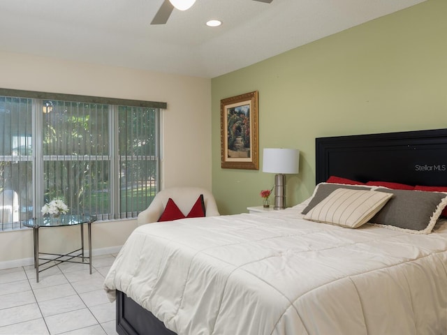 bedroom with ceiling fan and light tile patterned floors