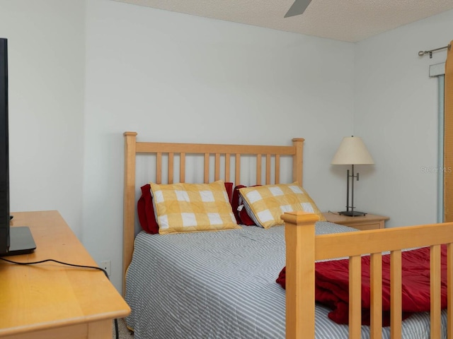 bedroom with a textured ceiling and ceiling fan