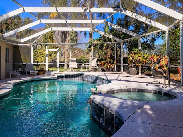 view of pool with pool water feature, a lanai, an in ground hot tub, and a patio