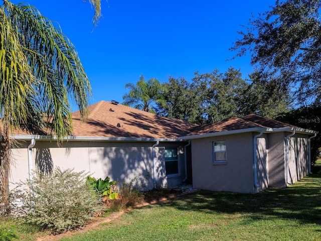 rear view of house featuring a lawn