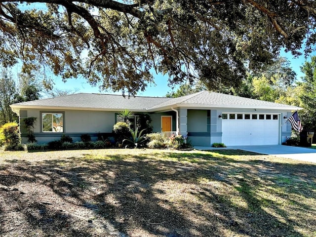 ranch-style home with a front lawn and a garage