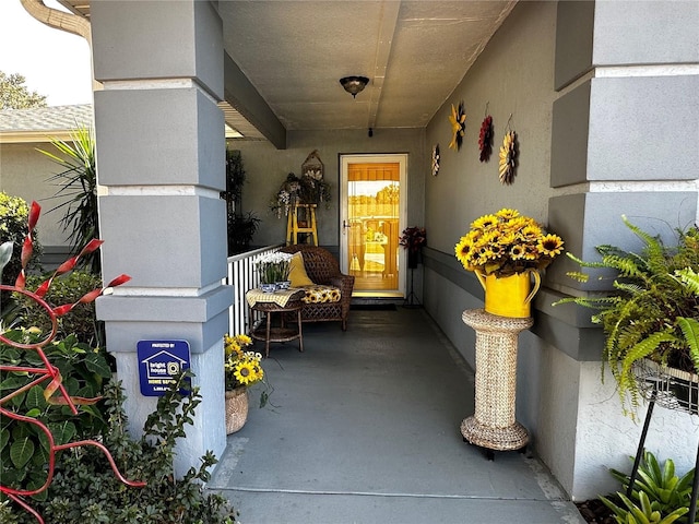 view of exterior entry with covered porch