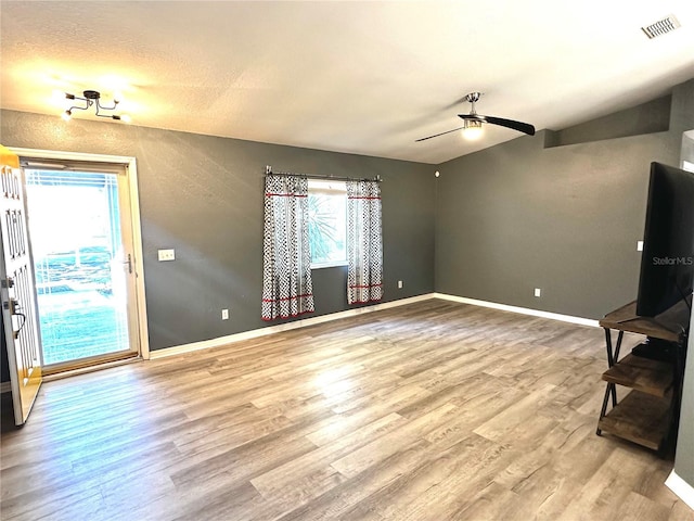 unfurnished living room with wood-type flooring and ceiling fan