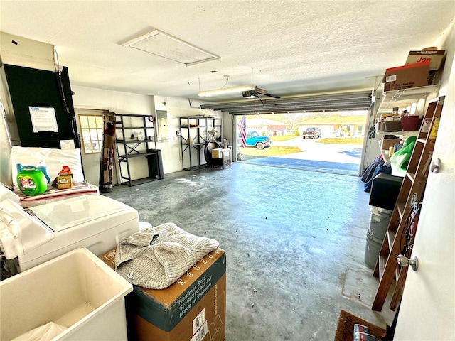 garage featuring a garage door opener and separate washer and dryer