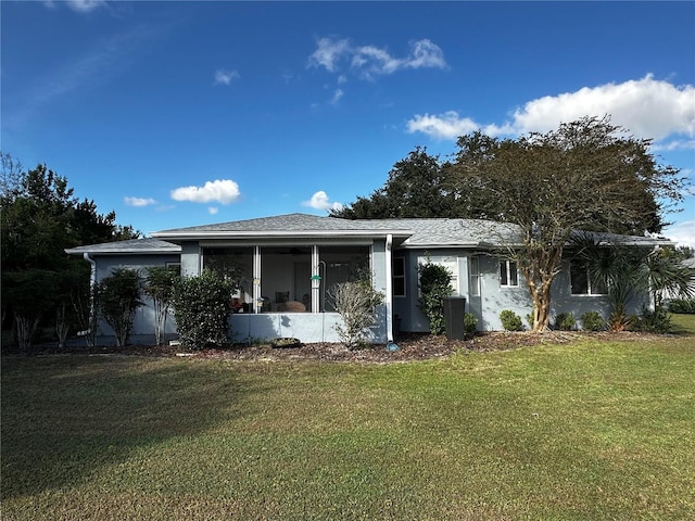 view of front of property featuring a sunroom and a front yard