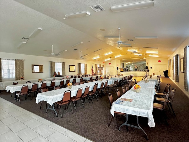 dining area featuring ceiling fan and vaulted ceiling