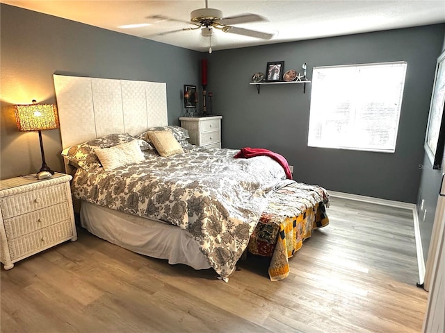 bedroom featuring ceiling fan and hardwood / wood-style flooring