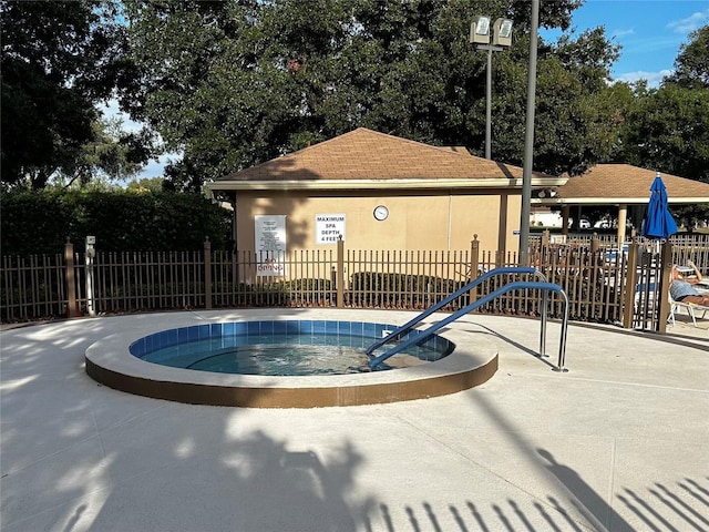 view of pool with a hot tub