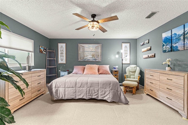 bedroom featuring ceiling fan, multiple windows, a textured ceiling, and carpet flooring