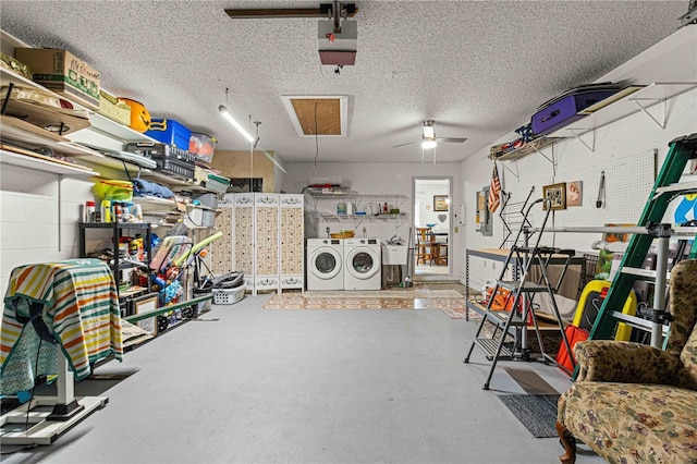 garage featuring a garage door opener, ceiling fan, and independent washer and dryer