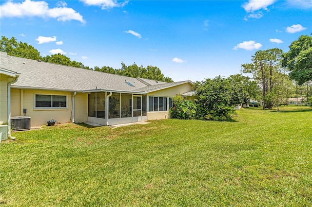 back of property featuring central AC, a sunroom, and a yard